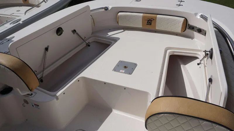 Slide: The Image of 2023 Carolina Skiff 24 Ultra Elite boat interior with storage compartments. - 7