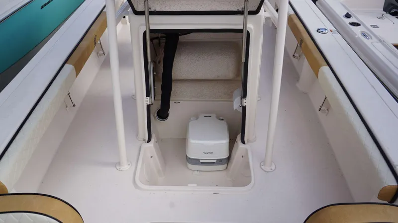 Slide: The Image of 2023 Carolina Skiff 24 Ultra Elite boat interior with portable toilet. - 8