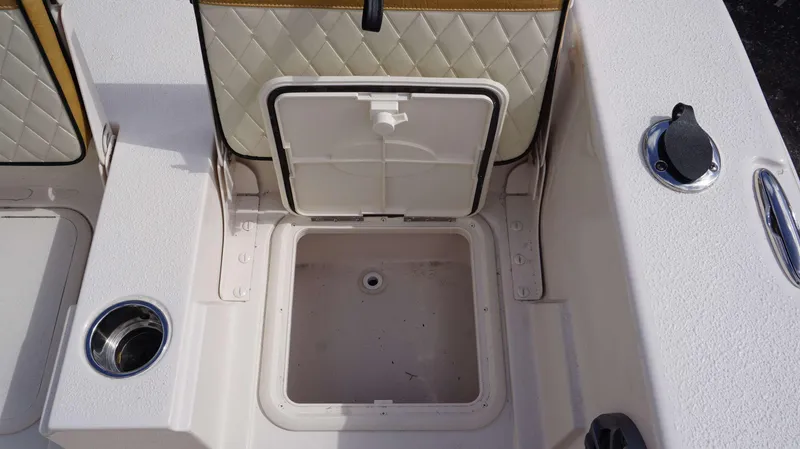 Slide: The Image of 2023 Carolina Skiff 24 Ultra Elite boat storage compartment with open hatch. - 9