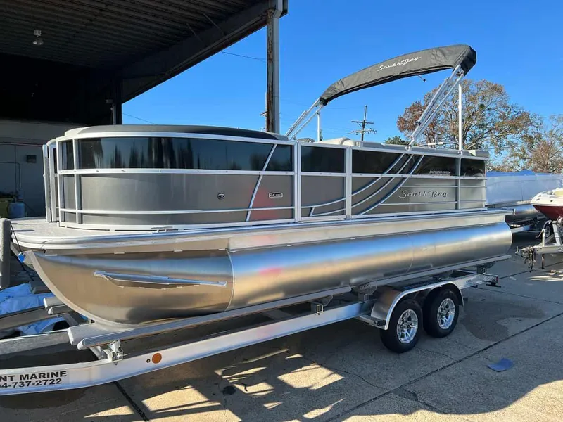 Slide: The Image of 2023 South Bay 220CR LE 2.0 pontoon boat on a trailer. - 1