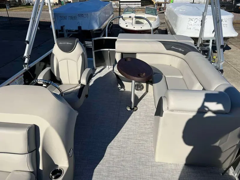 Slide: The Image of 2023 South Bay 220CR LE 2.0 pontoon boat interior with seating and table. - 10