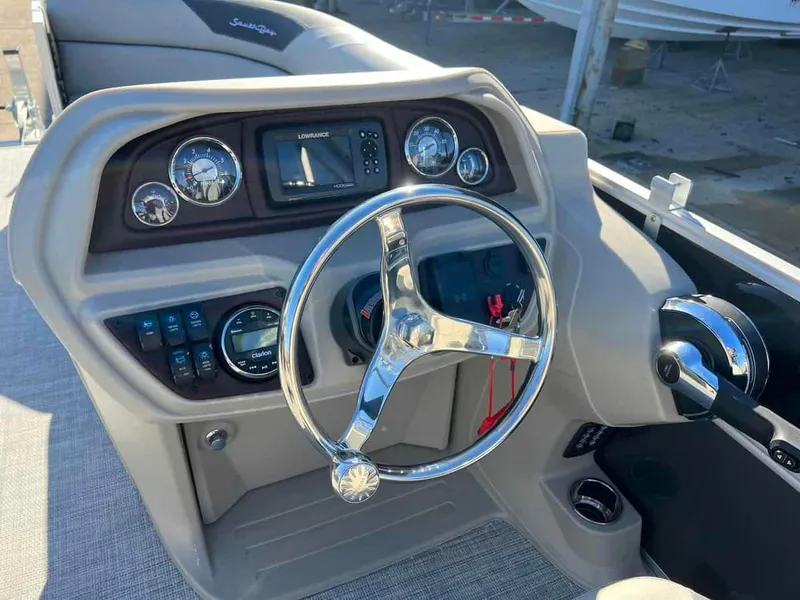 Slide: The Image of 2023 South Bay 220CR LE 2.0 boat dashboard with steering wheel and control panel. - 5
