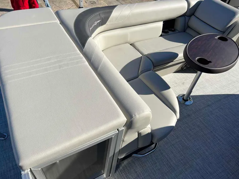 Slide: The Image of 2023 South Bay 220CR LE 2.0 pontoon boat interior with plush seating and table. - 8