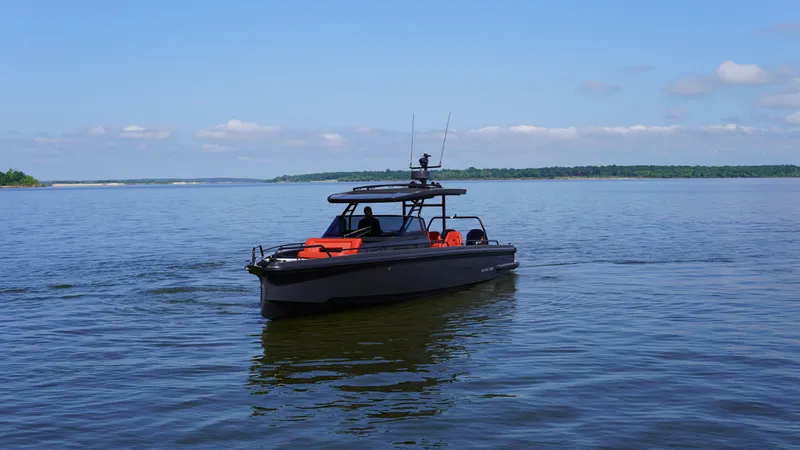 Slide: The Image of BRABUS Shadow 900 Sun Top 2020 boat cruising on a calm lake under a clear blue sky. - 13