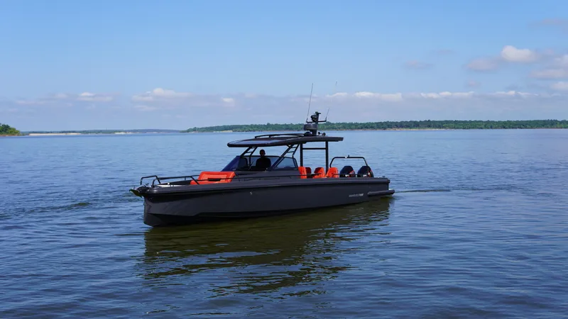 Slide: The Image of BRABUS Shadow 900 Sun Top 2020 boat cruising on a calm lake under a clear blue sky. - 14