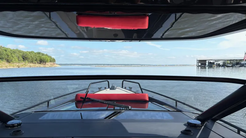 Slide: The Image of BRABUS Shadow 900 Sun Top 2020 on serene lake with clear sky and distant shoreline. - 17