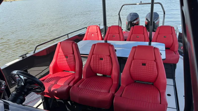 Slide: The Image of 2020 BRABUS Shadow 900 Sun Top with red seats and dual engines on a calm lake. - 21
