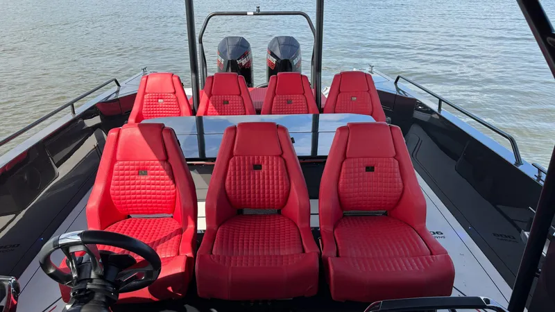 Slide: The Image of Red leather seats on 2020 BRABUS Shadow 900 Sun Top boat, with dual engines, on water. - 23