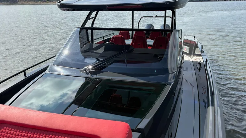 Slide: The Image of BRABUS Shadow 900 Sun Top 2020 luxury boat with sleek design and red seating. - 25