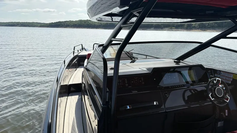 Slide: The Image of 2020 BRABUS Shadow 900 Sun Top yacht on calm water, featuring sleek design and modern dashboard. - 29