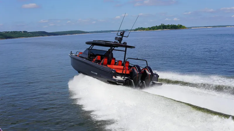 Slide: The Image of 2020 BRABUS Shadow 900 Sun Top cruising on a calm lake under a clear sky. - 3