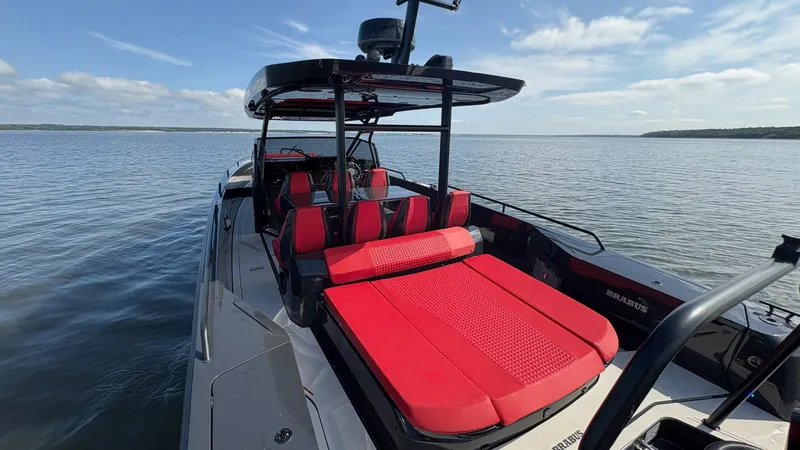 Slide: The Image of BRABUS Shadow 900 Sun Top 2020 with red seating on calm water. - 36