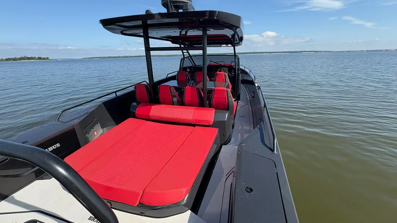 Slide: The Image of 2020 BRABUS Shadow 900 Sun Top boat with red seating on calm water. - 37