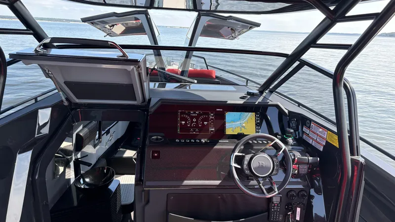 Slide: The Image of Cockpit of 2020 BRABUS Shadow 900 Sun Top with advanced navigation system on open water. - 41