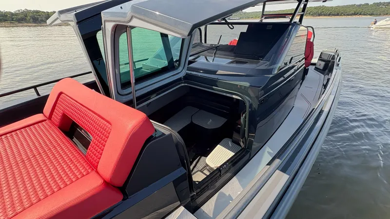 Slide: The Image of BRABUS Shadow 900 Sun Top 2020 with red seating, sleek design on calm water. - 46