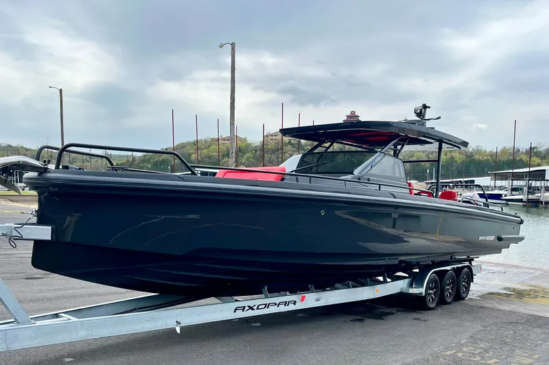 Slide: The Image of 2020 BRABUS Shadow 900 Sun Top boat on trailer, sleek design, dockside setting. - 55