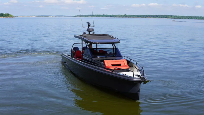 Slide: The Image of BRABUS Shadow 900 Sun Top 2020 speeding on a lake with red seating. - 6