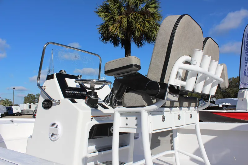 Slide: The Image of 2023 Sea Pro 208 Bay boat console and seating under clear blue sky. - 10