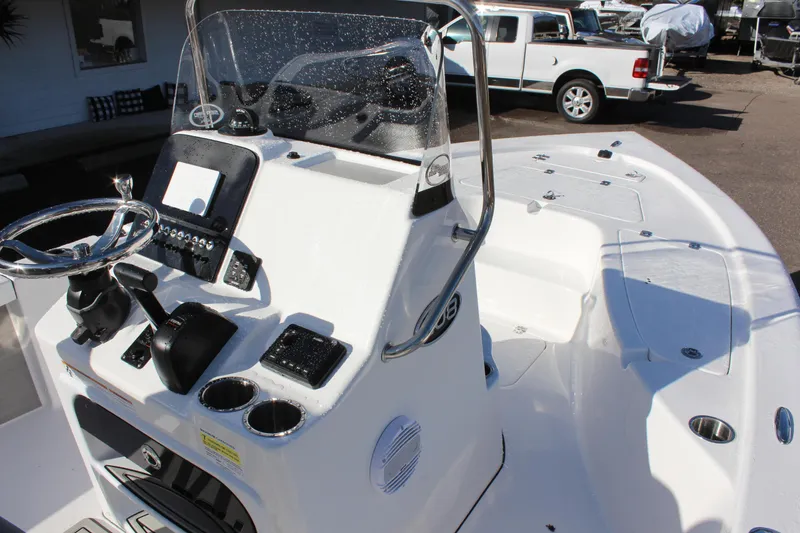 Slide: The Image of 2023 Sea Pro 208 Bay boat console and deck, featuring steering wheel and control panel. - 11