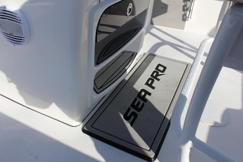 Slide: The Image of 2023 Sea Pro 208 Bay boat interior with branded mat and storage compartments. - 17