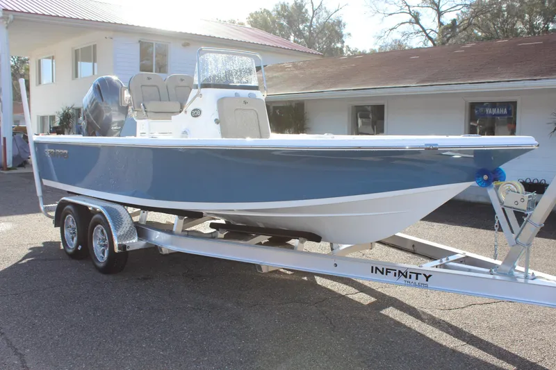 Slide: The Image of 2023 Sea Pro 208 Bay boat on Infinity trailer, parked outdoors. - 4