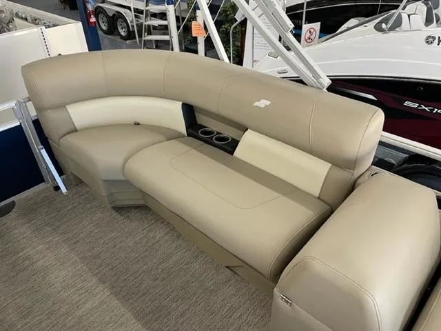 Slide: The Image of 2023 Starcraft LX 16 R boat interior with beige seating and cup holders. - 10