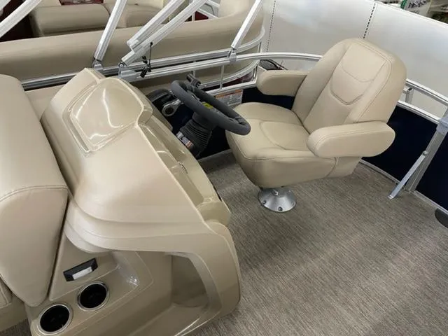 Slide: The Image of 2023 Starcraft LX 16 R boat interior with captain's chair and steering console. - 11