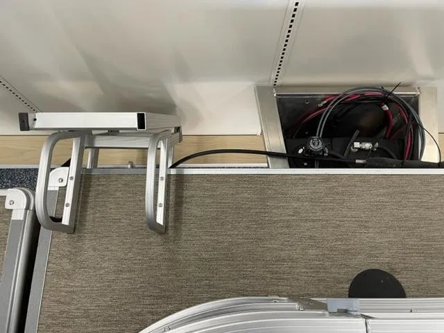 Slide: The Image of 2023 Starcraft LX 16 R boat interior with wiring and ladder. - 13