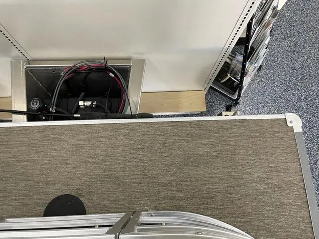 Slide: The Image of 2023 Starcraft LX 16 R boat interior with storage compartment and wiring. - 14