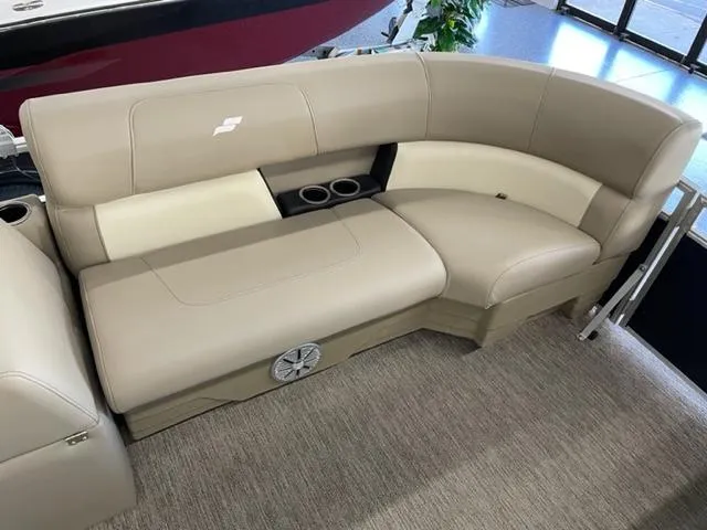 Slide: The Image of 2023 Starcraft LX 16 R boat interior with beige seating and cup holders. - 8
