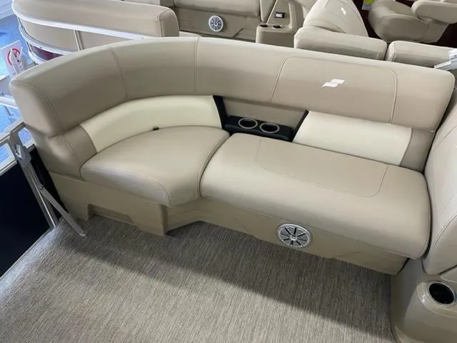 Slide: The Image of 2023 Starcraft LX 16 R boat interior with beige seating and cup holders. - 9