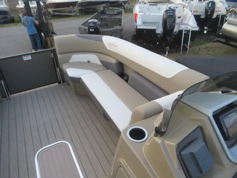 Slide: The Image of 2023 SunChaser Eclipse 25 LR DH boat interior with beige and white seating. - 11
