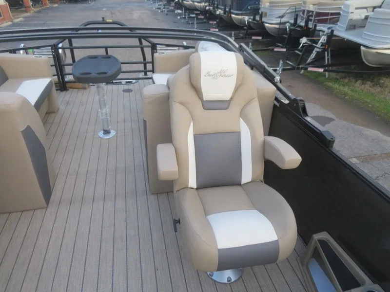 Slide: The Image of 2023 SunChaser Eclipse 25 LR DH boat interior with captain's chair and deck view. - 13