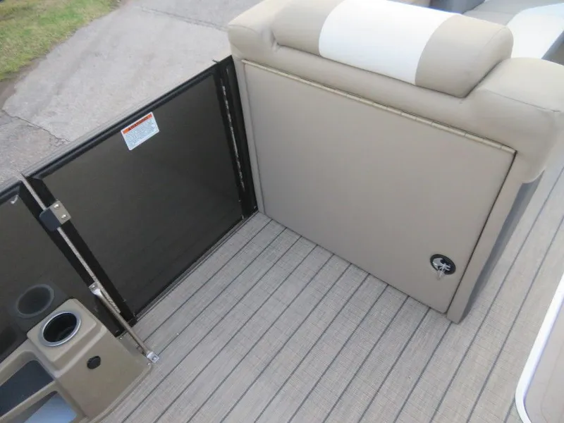 Slide: The Image of 2023 SunChaser Eclipse 25 LR DH boat interior, featuring beige seating and deck flooring. - 14