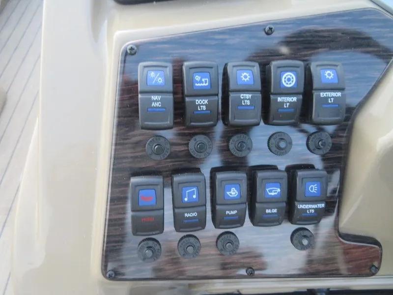 Slide: The Image of Control panel of a 2023 SunChaser Eclipse 25 LR DH boat with various switches. - 16