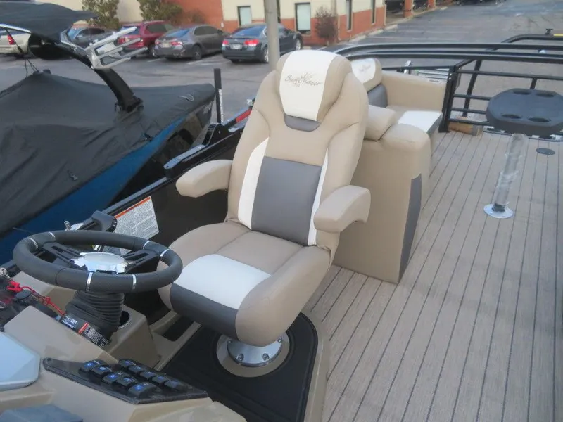 Slide: The Image of 2023 SunChaser Eclipse 25 LR DH boat interior with captain's chair and control console. - 17