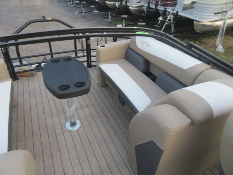 Slide: The Image of 2023 SunChaser Eclipse 25 LR DH pontoon boat interior with seating and table. - 23