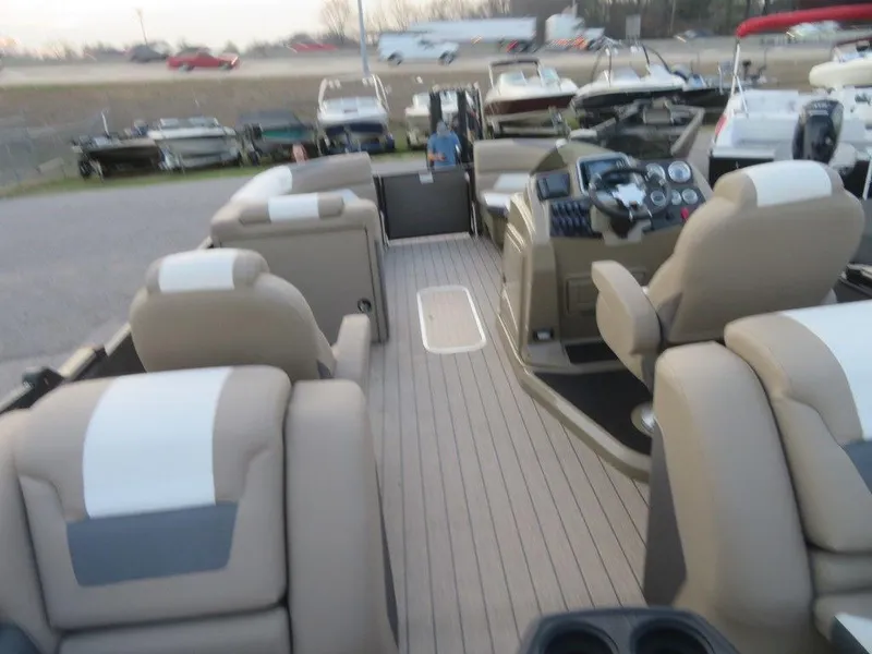 Slide: The Image of 2023 SunChaser Eclipse 25 LR DH pontoon boat interior with beige and white seating. - 27