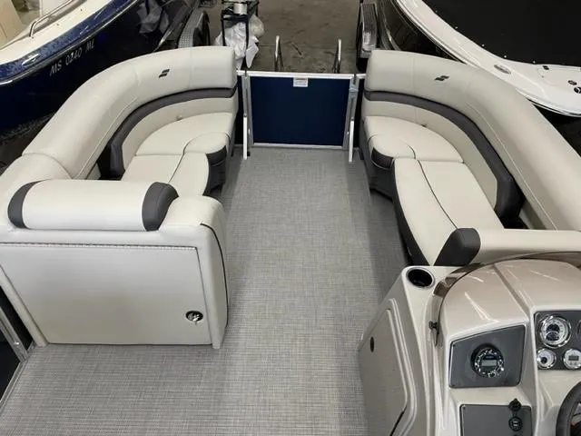 Slide: The Image of 2023 Starcraft EX 22 R pontoon boat interior with plush seating and modern dashboard. - 14