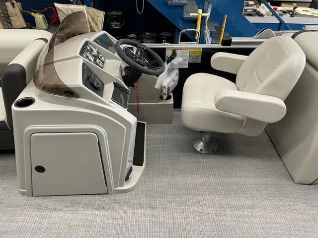 Slide: The Image of 2023 Starcraft EX 22 R boat helm with captain's chair and control panel. - 18