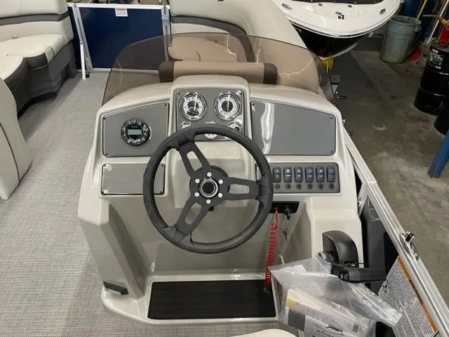 Slide: The Image of 2023 Starcraft EX 22 R boat dashboard with steering wheel and control panel. - 19