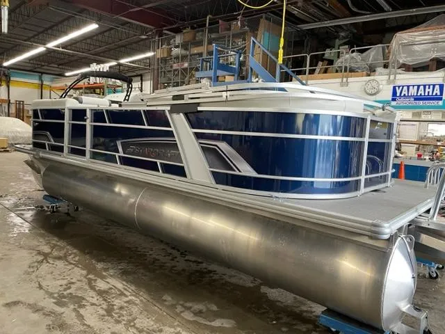Slide: The Image of 2023 Starcraft EX 22 R pontoon boat in a workshop. - 26