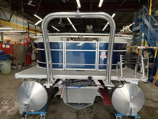 Slide: The Image of 2023 Starcraft EX 22 R pontoon boat in a workshop. - 27
