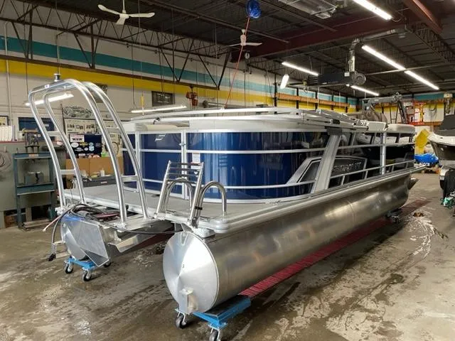 Slide: The Image of 2023 Starcraft EX 22 R pontoon boat in a workshop. - 28