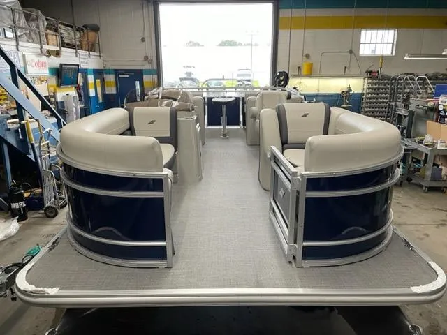 Slide: The Image of 2023 Starcraft EX 22 R pontoon boat interior in a workshop. - 3