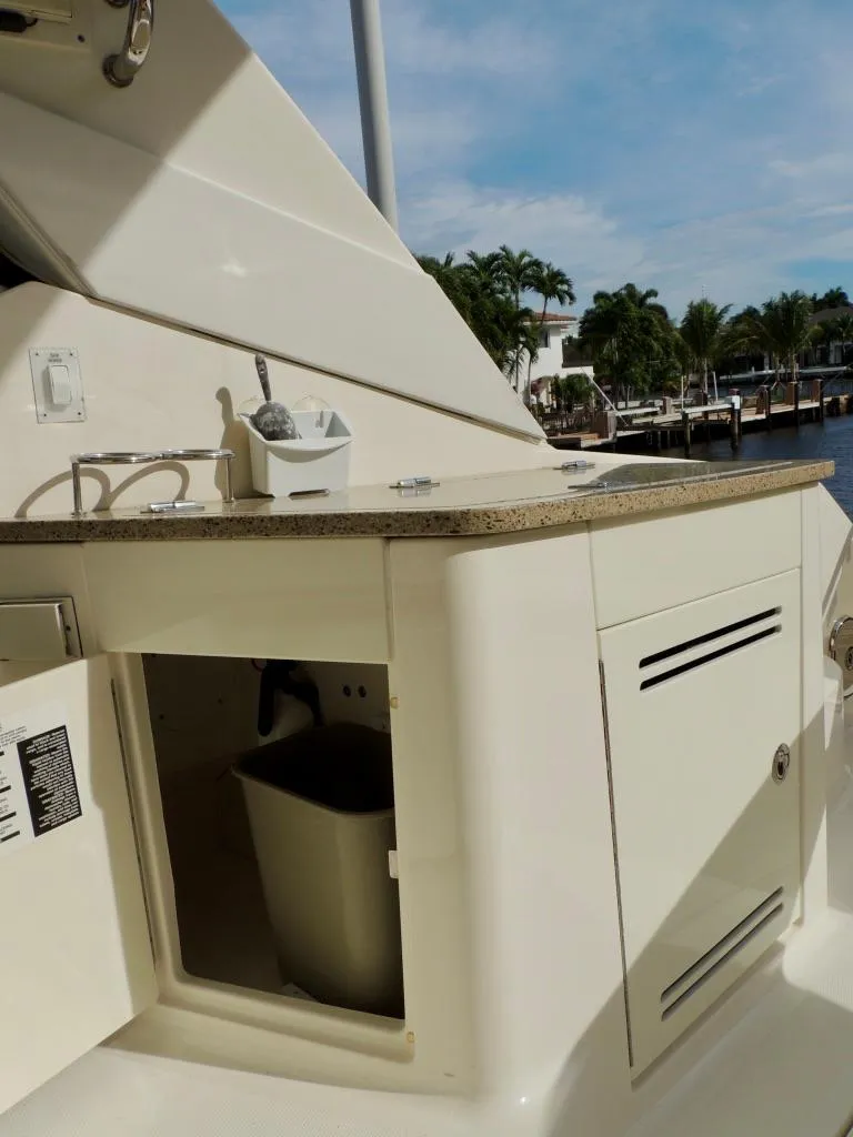 Slide: The Image of 2016 Sea Ray 350 Sundancer boat kitchenette with sink and storage. - 29