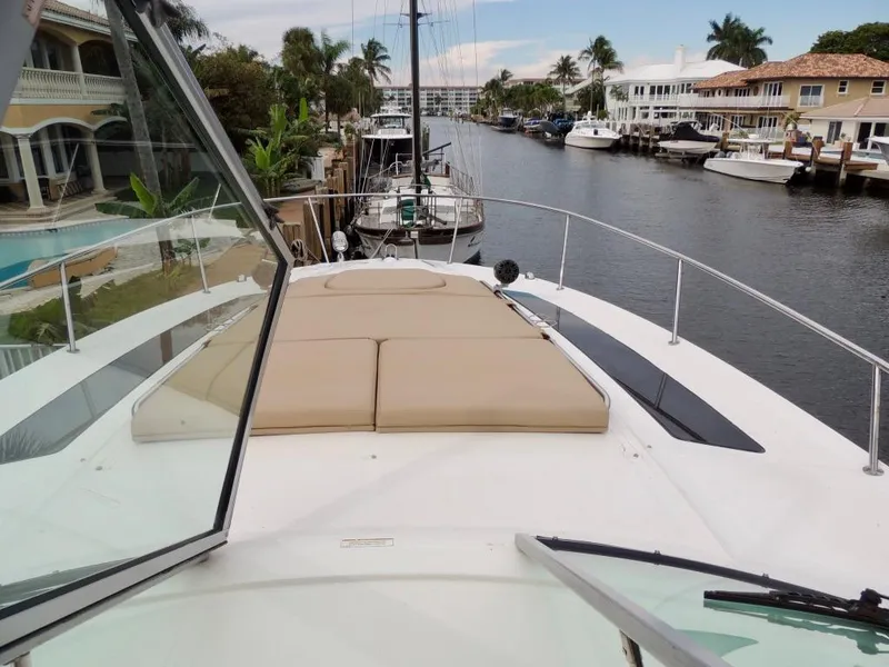 Slide: The Image of 2016 Sea Ray 350 Sundancer yacht docked in a canal with waterfront homes. - 33