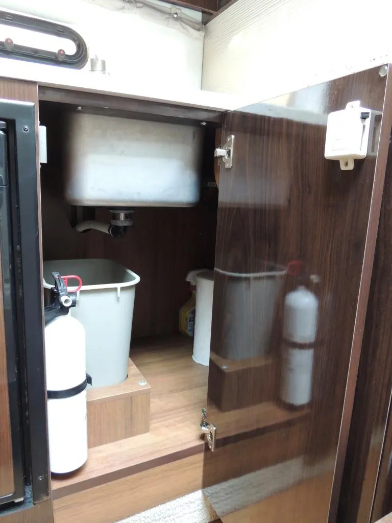 Slide: The Image of Open cabinet under sink in 2016 Sea Ray 350 Sundancer boat. - 43