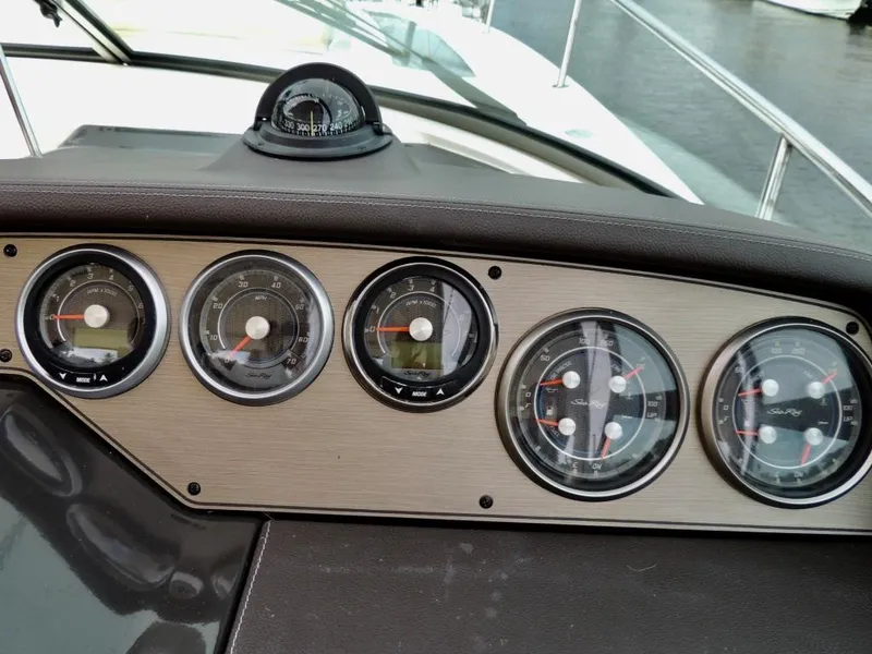Slide: The Image of Dashboard of a 2016 Sea Ray 350 Sundancer boat with gauges and compass. - 6