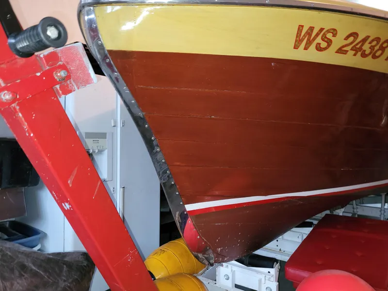 Slide: The Image of 1953 Chris-Craft HOLIDAY 24 wooden boat on a red trailer in a garage. - 12